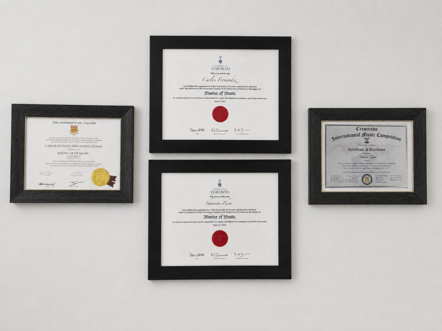 Framed music degrees and a competition certificate hanging on the studio wall